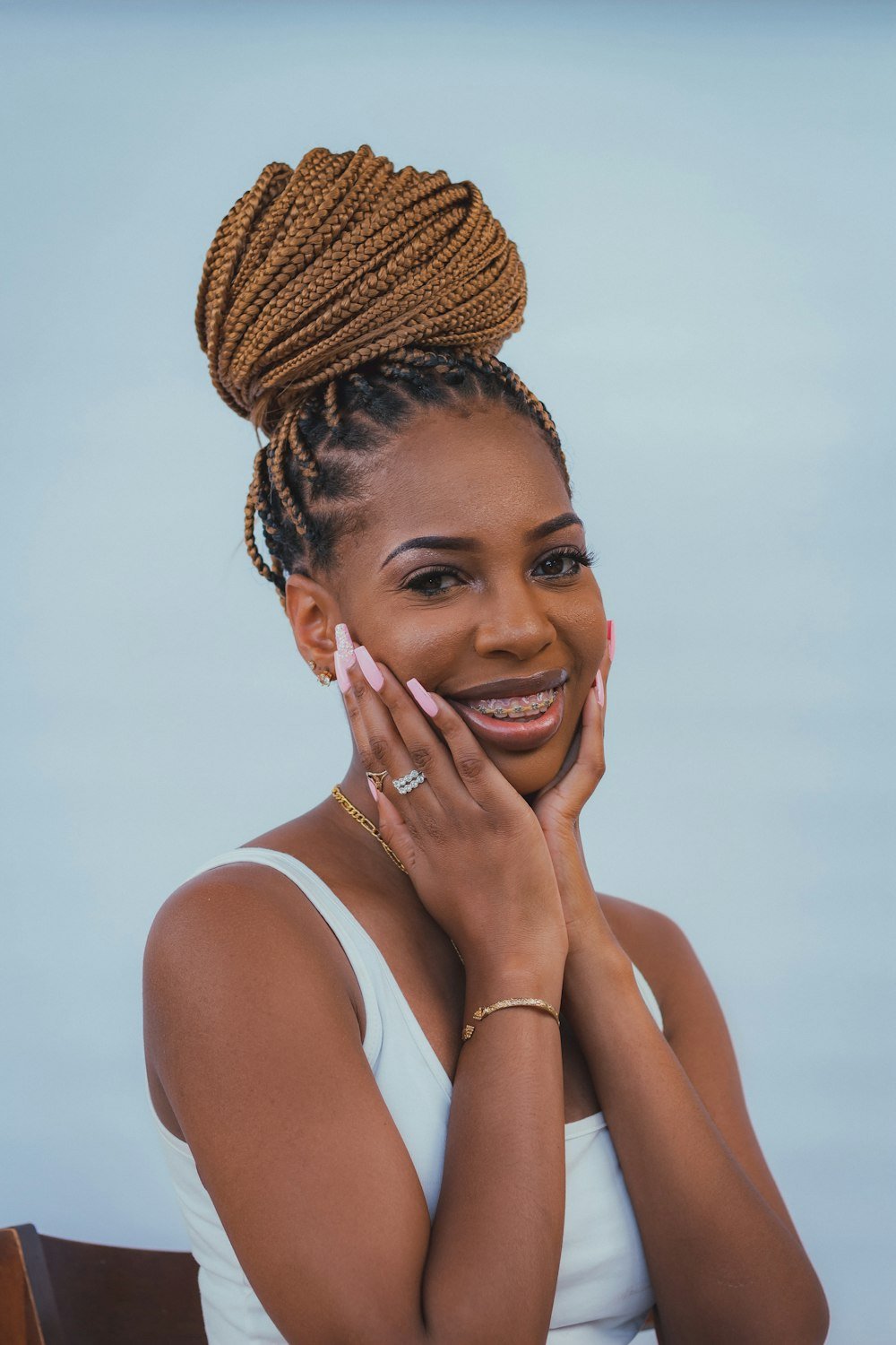 Smiling woman with braids in a high bun