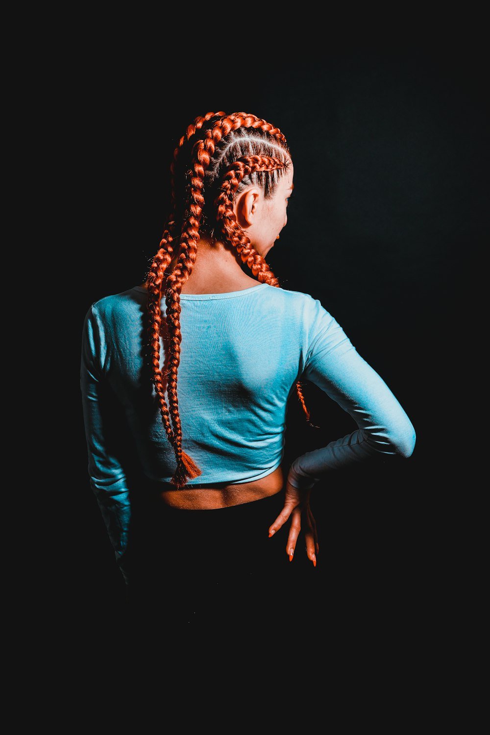 Long feed-in braids seen from behind